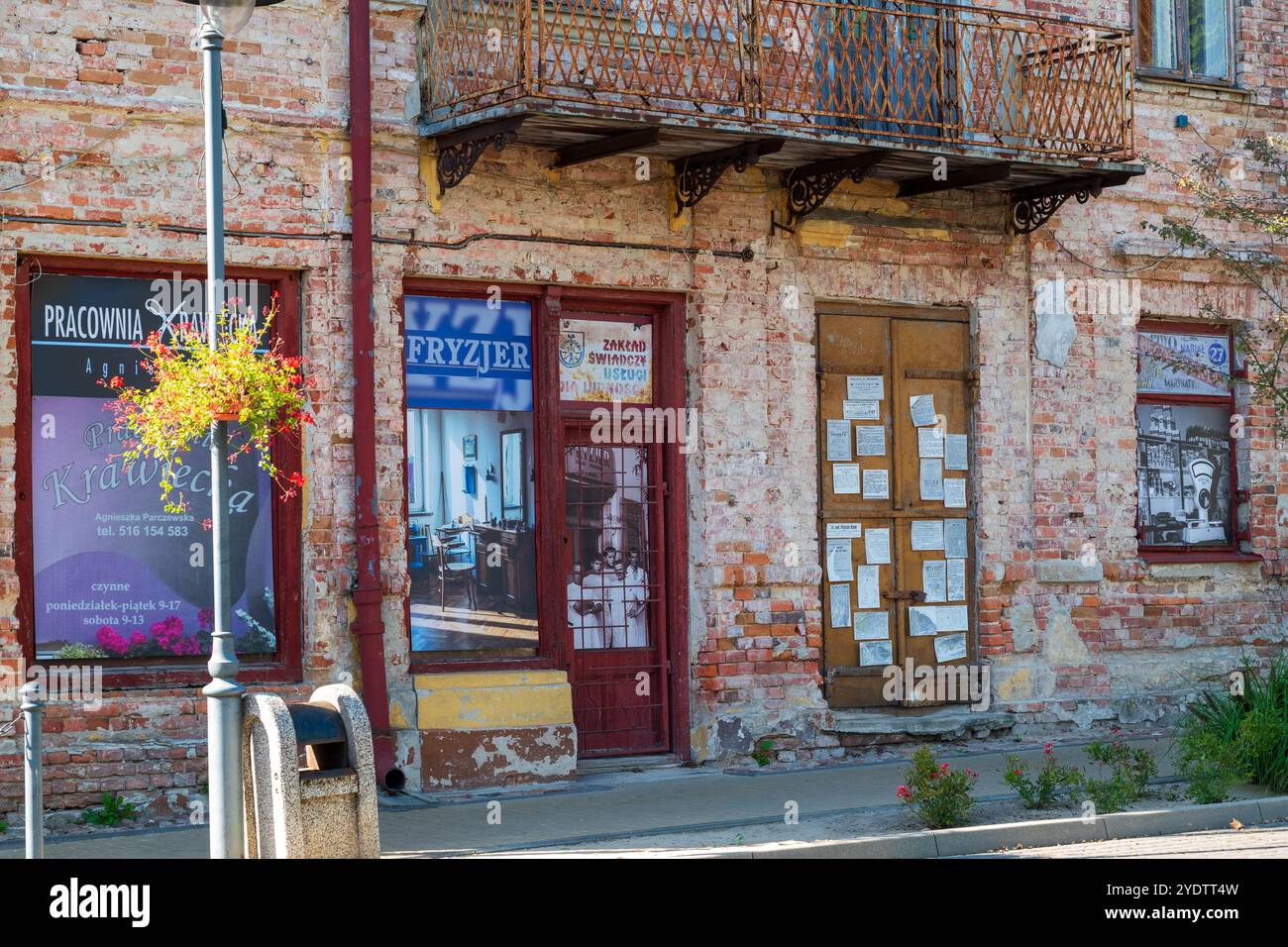 Wlodawa, Poland 23 September 2024 old run down tennament house and store front Stock Photo