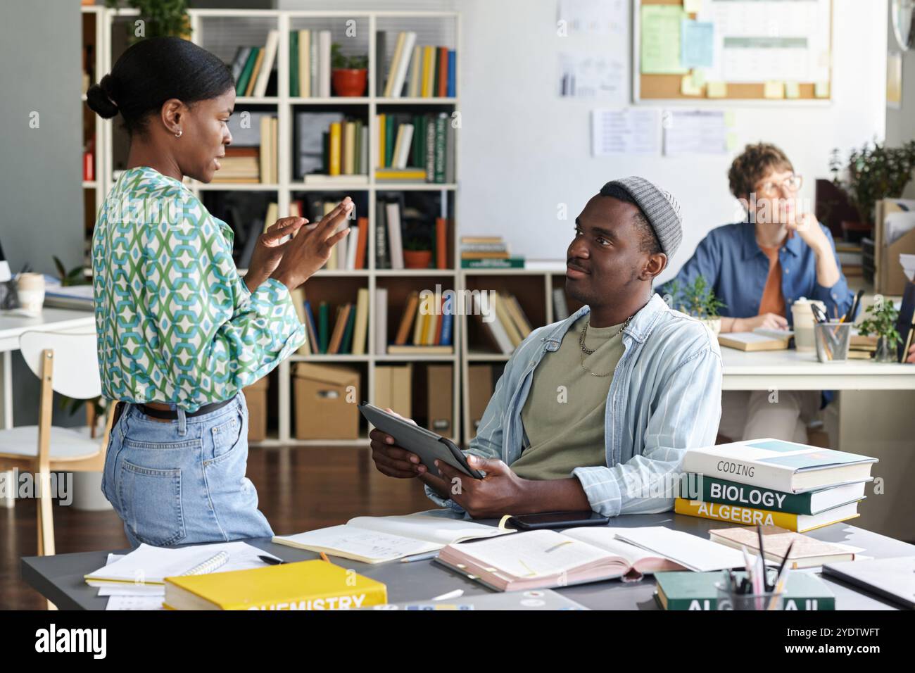 Discussing Project Details in Modern Office Space Stock Photo