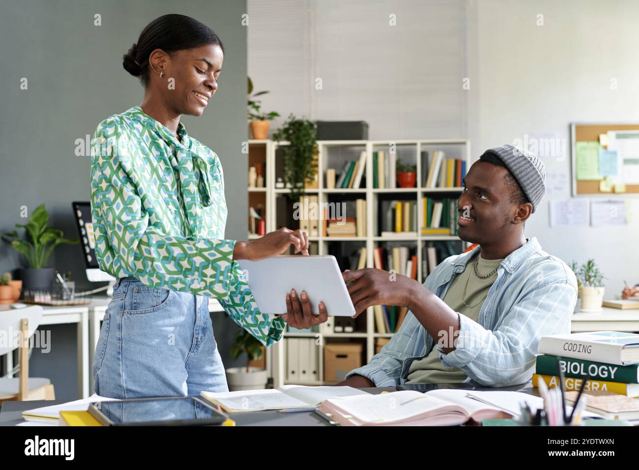 Discussing Project Details in Modern Office Environment Stock Photo