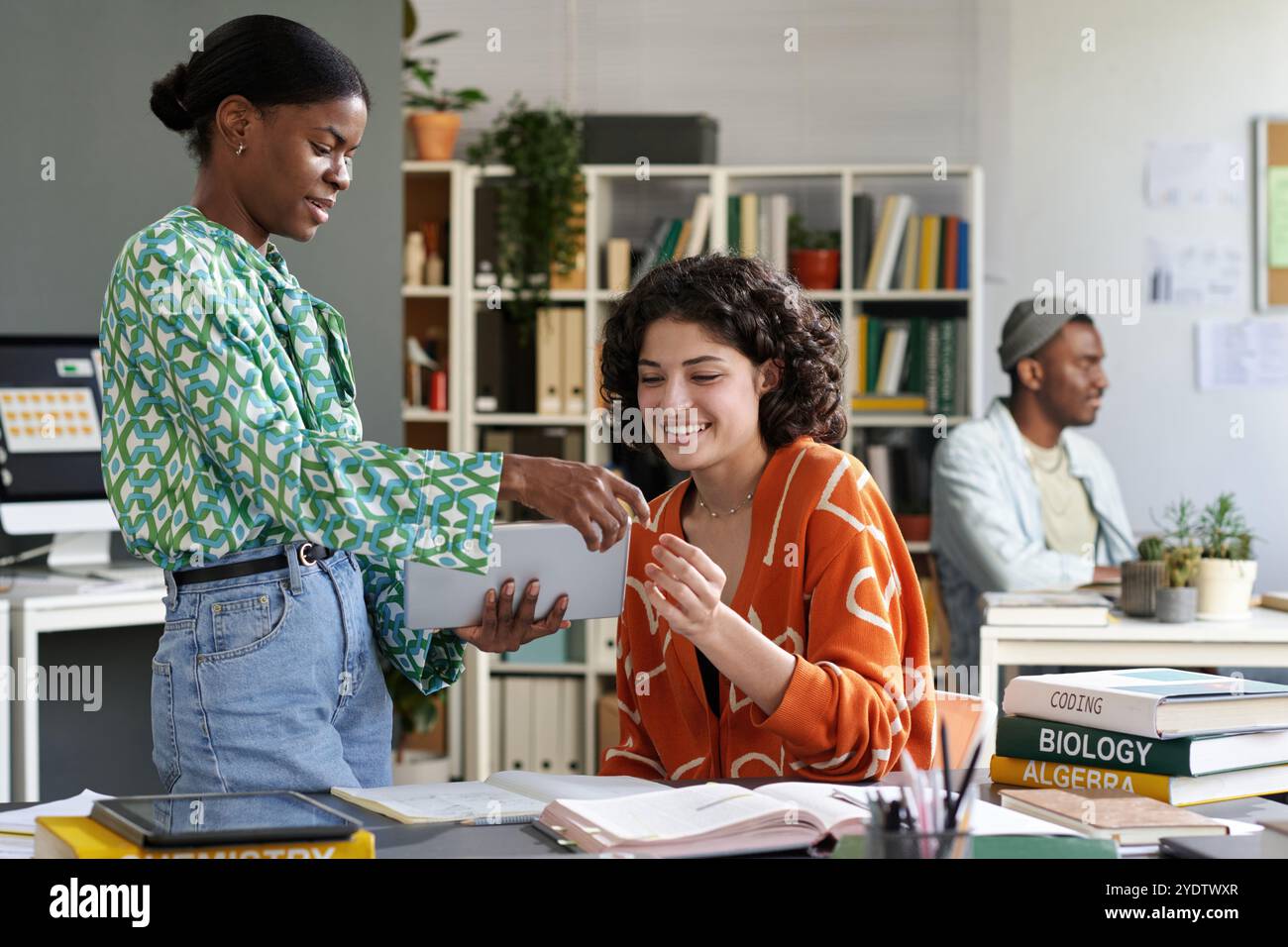 Collaborating on Academic Project in Modern Classroom Stock Photo