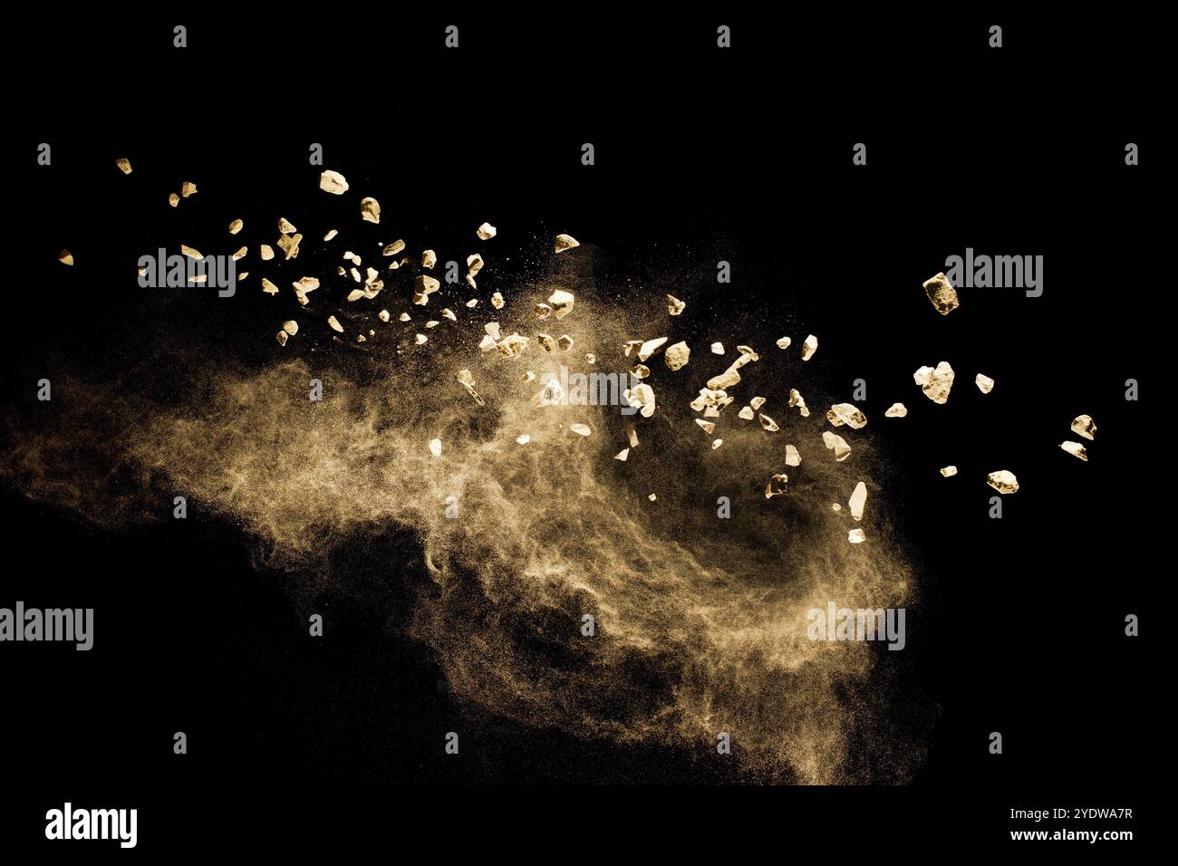Split debris of stone exploding with brown powder against black background Stock Photo