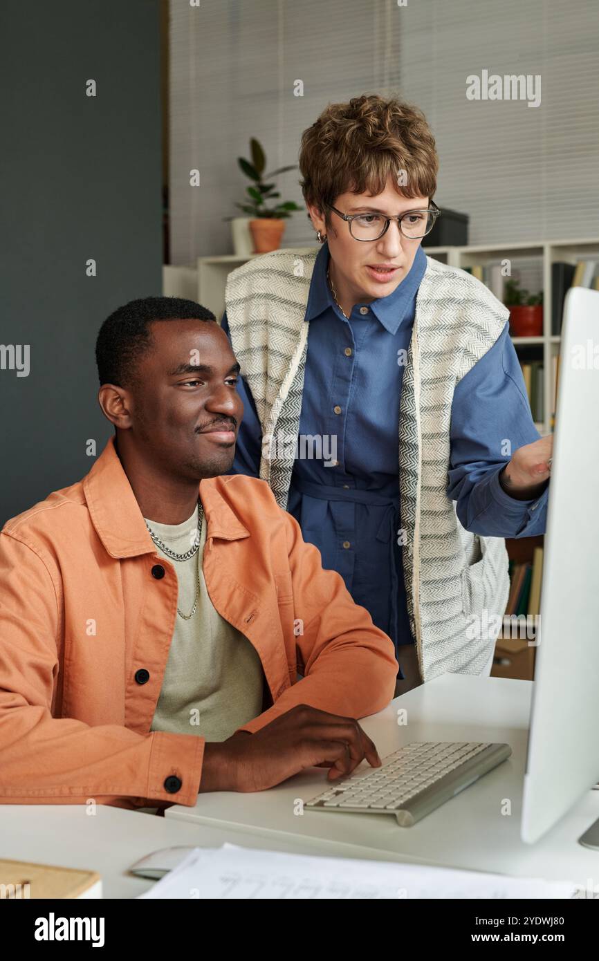 Collaborating on Project in Modern Office Setting Stock Photo
