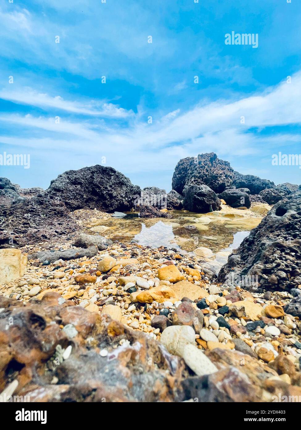 Beautiful image of a Senegalese beach, featuring rocks, sand, and clear, warm water. Buy the image to help donate for climate and environmental care - Smartphone Captured Stock Image