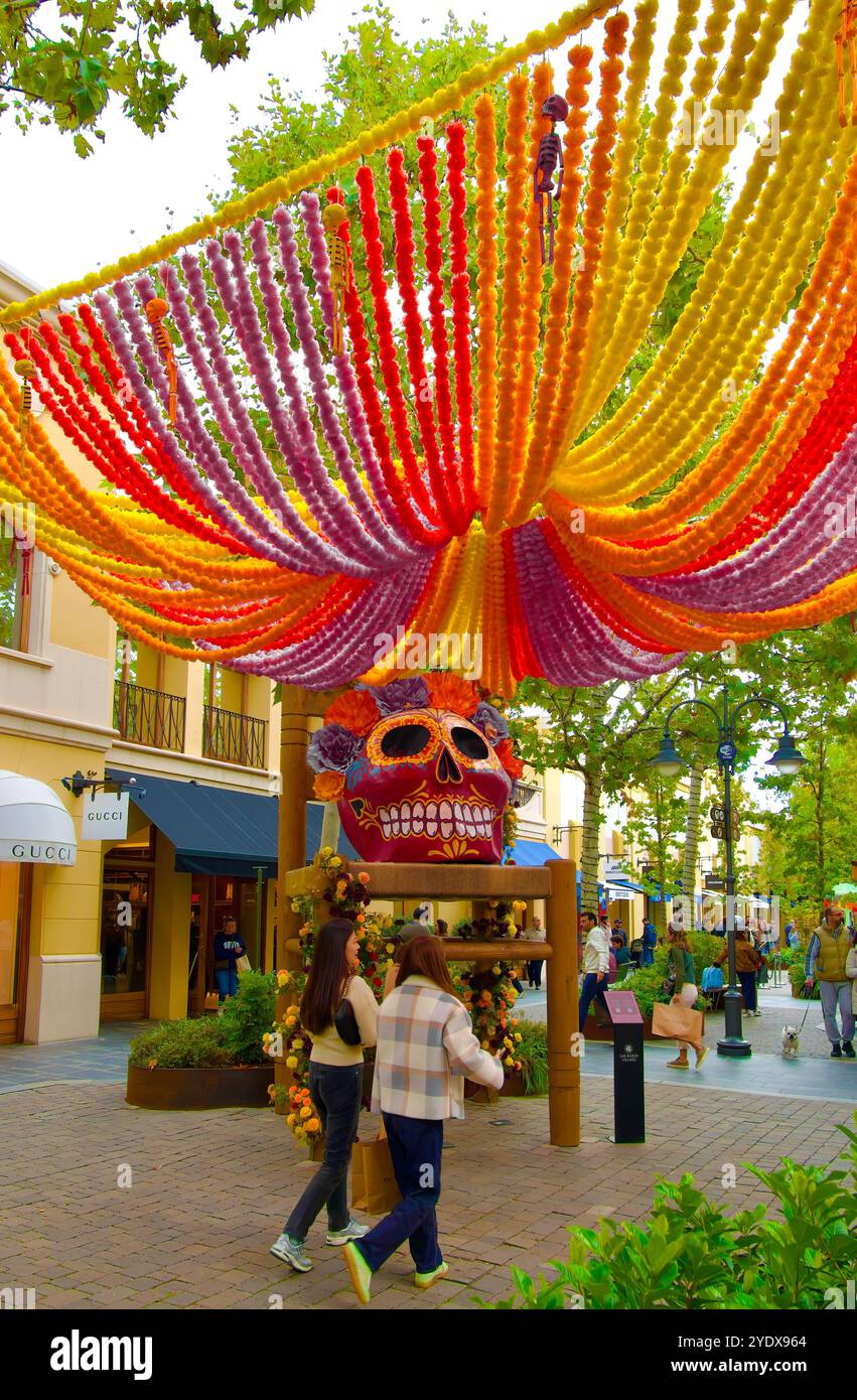 Giant papiermâché painted skull on a huge chair for Halloween