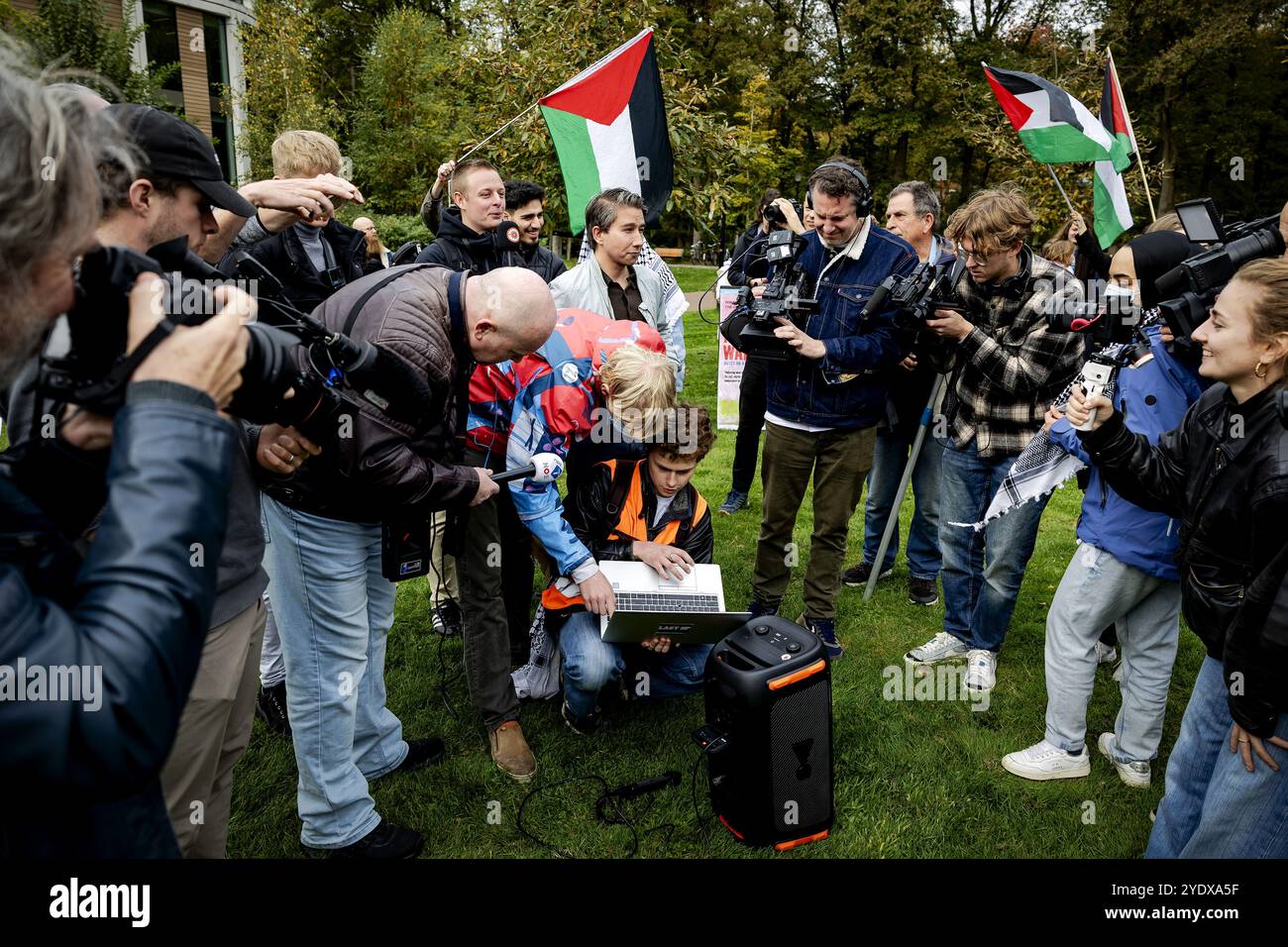 NIJMEGEN - Nijmegen Encampment activists and sympathizers are making laptops to watch controversial speaker Mohammed Khatib on the grounds of Radboud University. Khatib was actually supposed to be physically present on the university campus, but received an entry ban. ANP ROBIN VAN LONKHUIJSEN netherlands out - belgium out Stock Photo