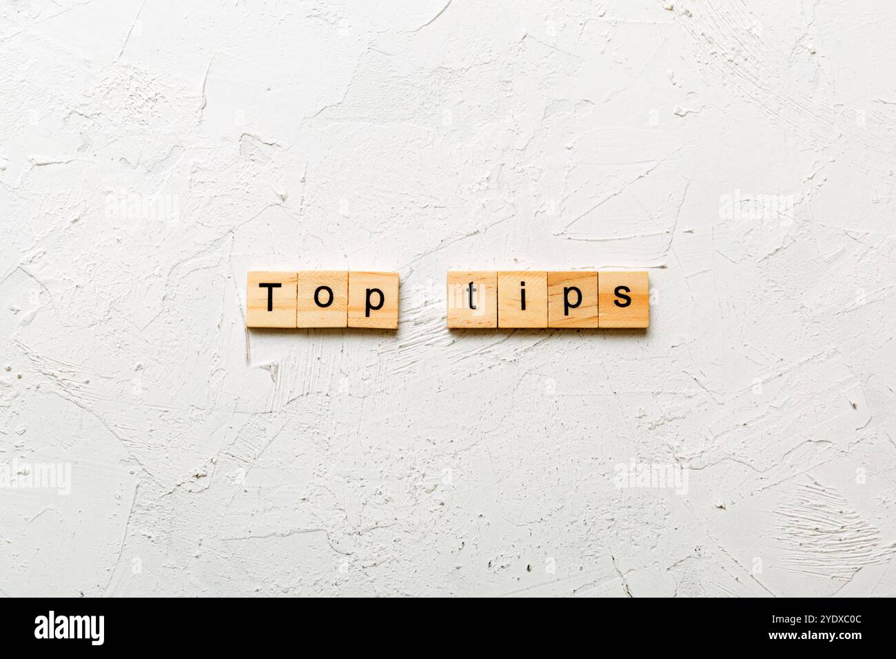 Top tips word written on wood block. Top tips text on cement table for ...