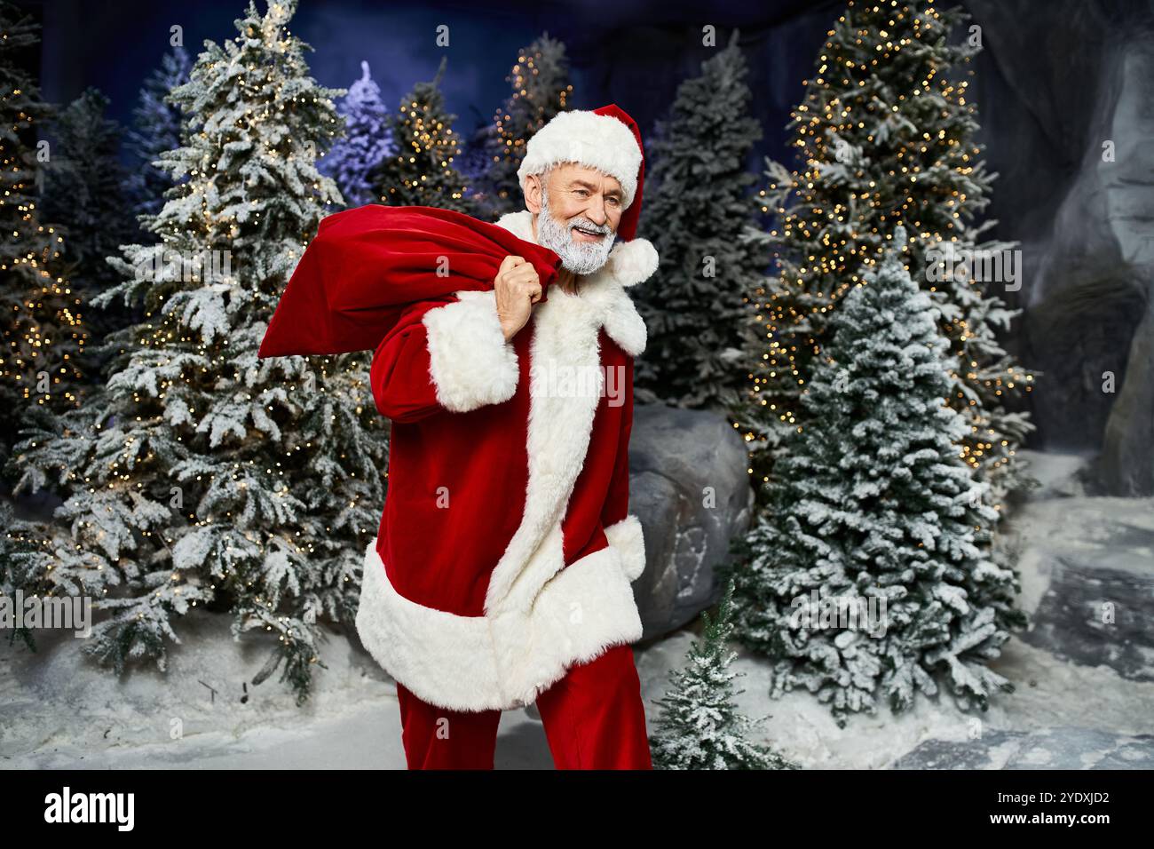 A cheerful figure dressed as Santa walks in a winter wonderland ...