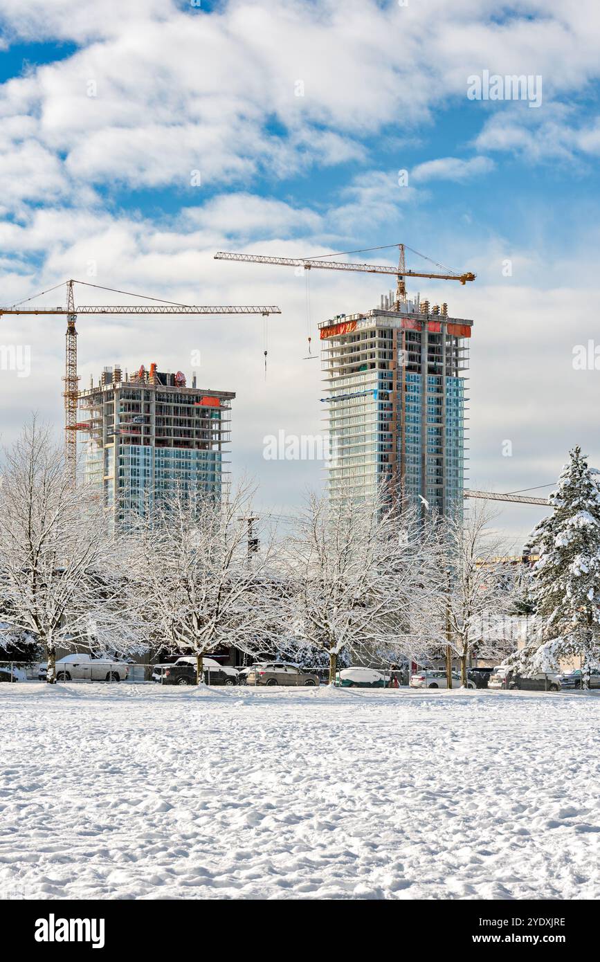 New high-rise residential buildings under construction on bright winter ...