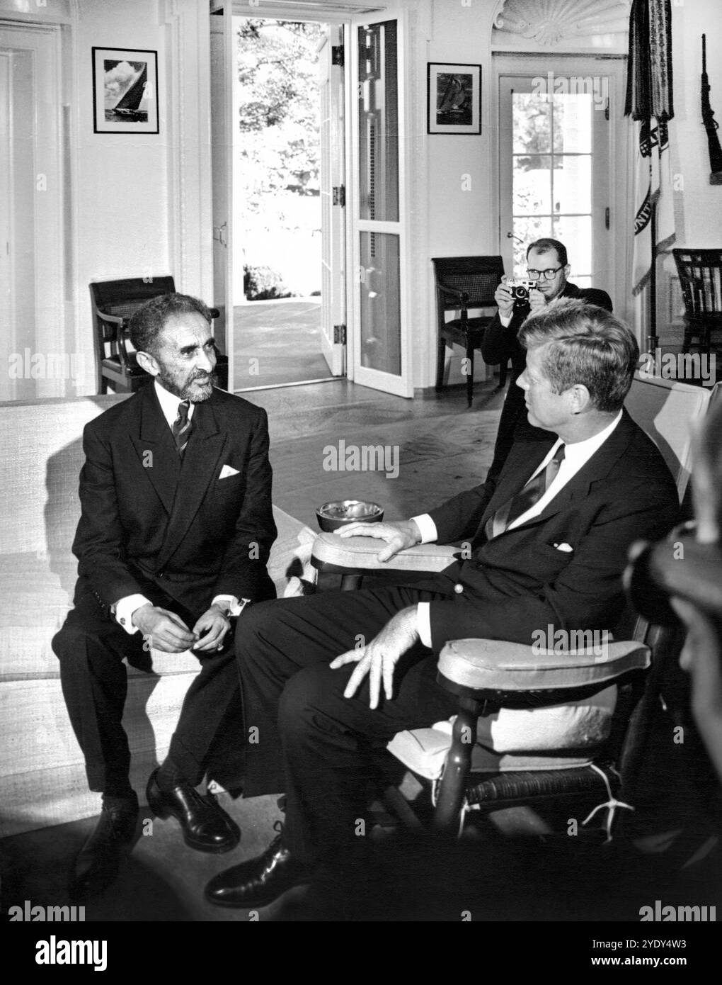 U.S. President John F. Kennedy (in rocking chair) meeting with Emperor of Ethiopia, Haile Selassie I, Oval Office, White House, Washington, D.C., Abbie Rowe, White House Photographs, October 1, 1963 Stock Photo