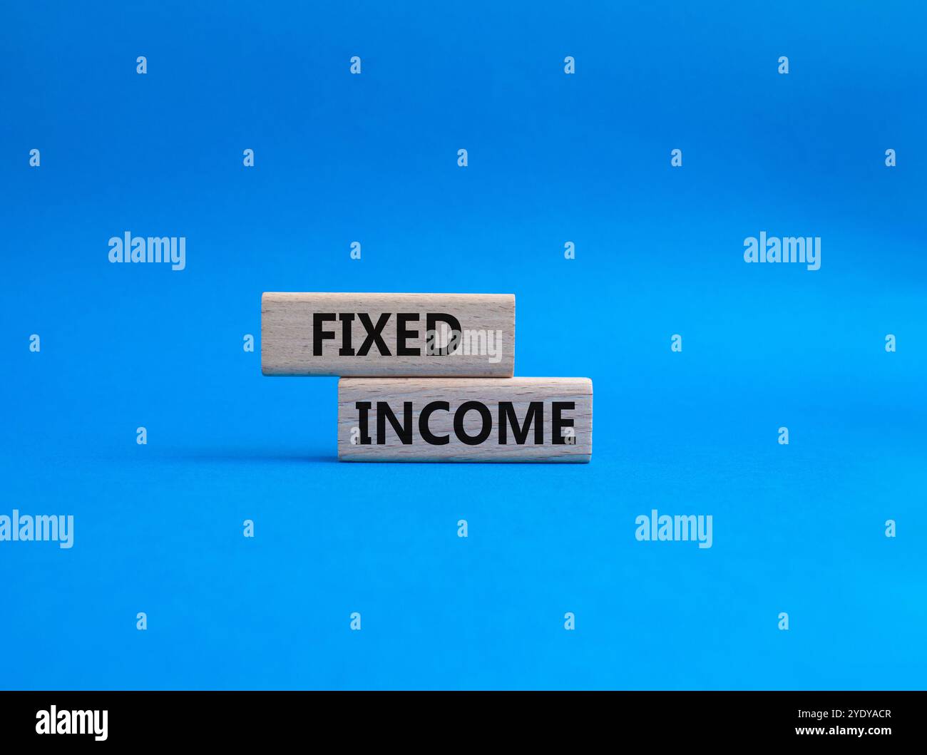 Fixed Income symbol. Concept word Fixed Income on wooden blocks. Beautiful blue background. Business and Fixed Income concept. Copy space Stock Photo