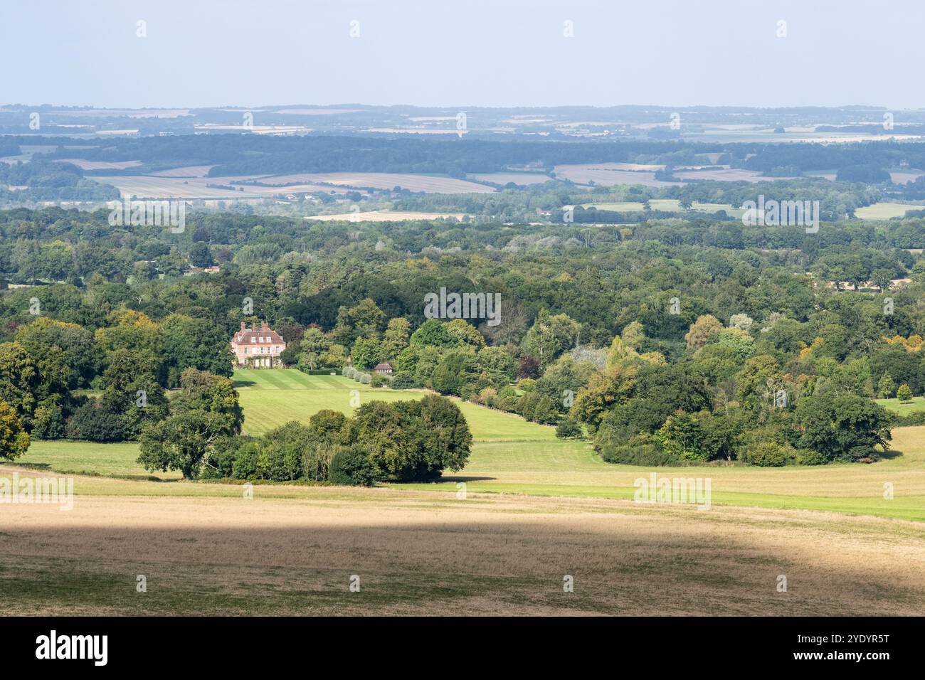 West Woodhay House is nestled in woodland in the Kennet Valley under England's Berkshire Downs hills. Stock Photo