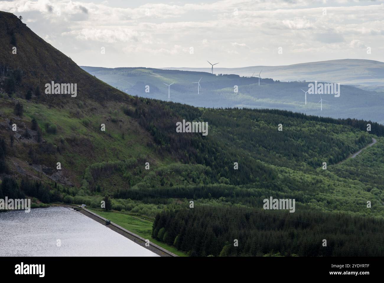 Wind turbines of the Maesgwyn Wind Farm stand above the Vale of Neath in the South Wales valleys, with the Black Mountain area of the Brecon Beacons b Stock Photo