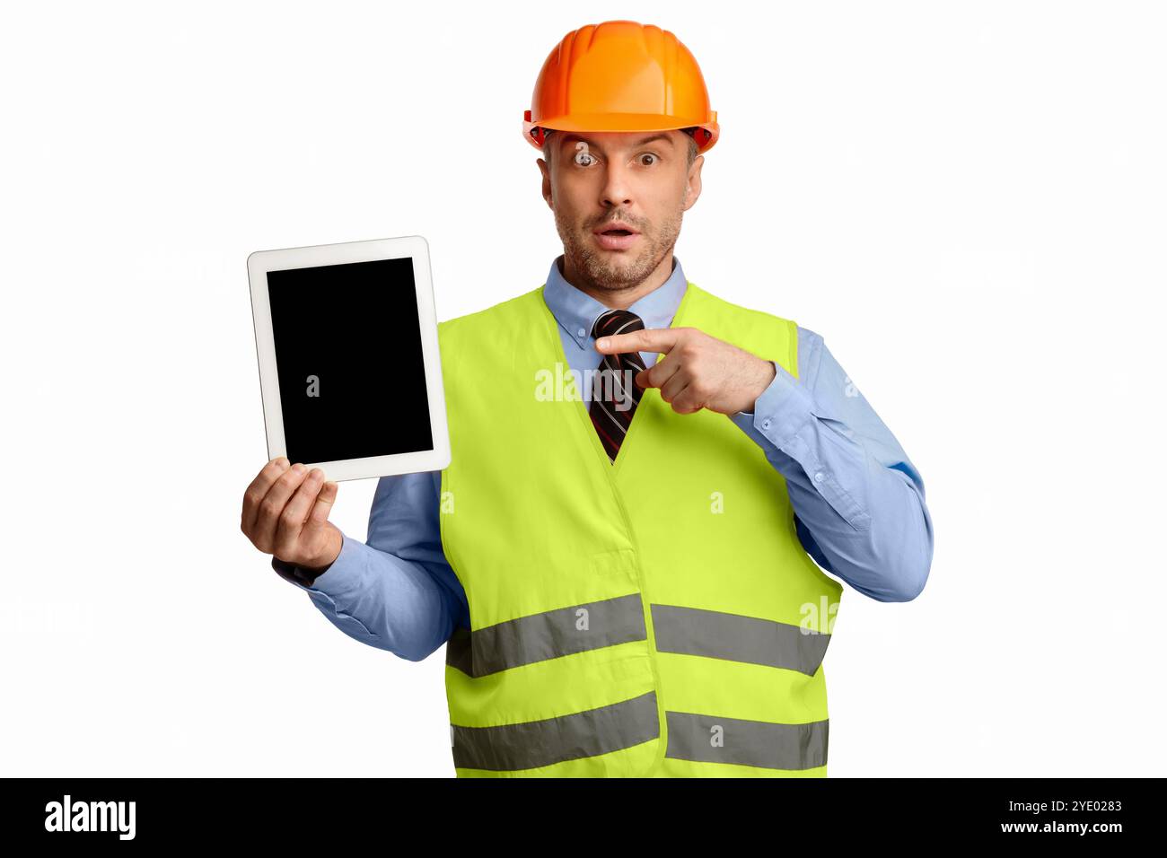Surprised Worker Man Showing Tablet Screen On White Studio Background Stock Photo
