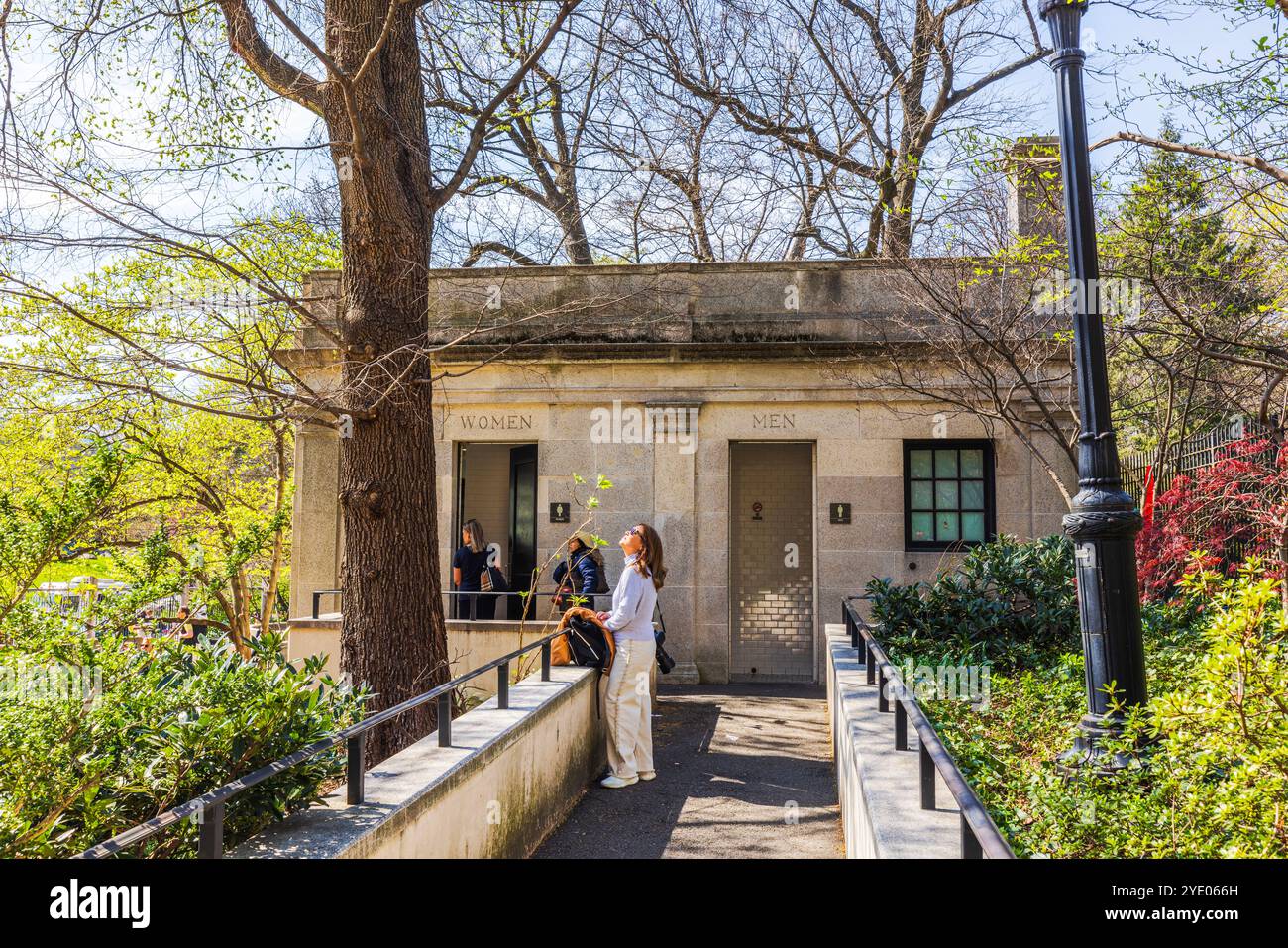 Visitors at public restroom in Central Park, surrounded by spring ...