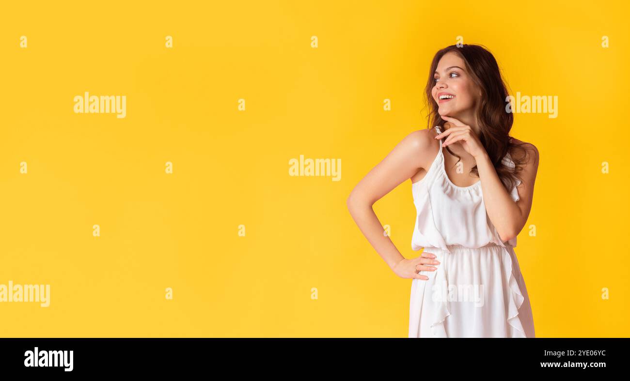 Beautiful lady in dress looking at copy space on colorful background Stock Photo