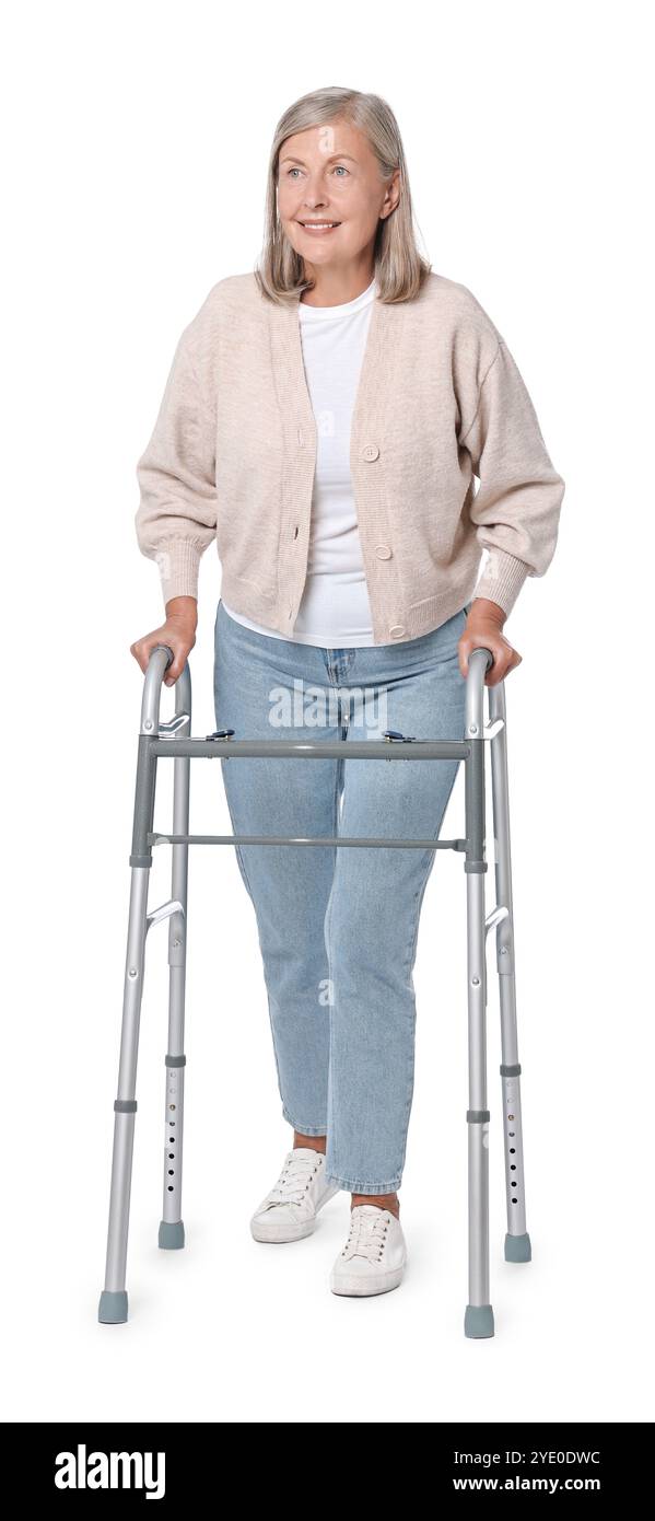 Senior woman using walking frame on white background Stock Photo - Alamy