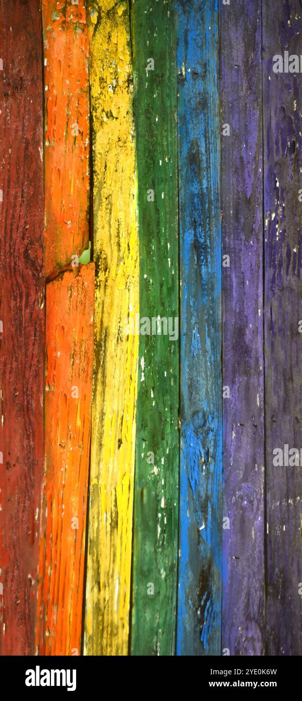 Rustic, wooden fence has been painted in the colors of the rainbow ...