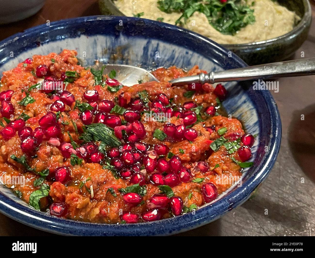 Mezze Platter with Muhammara, Baba Ganoush topped with pomegranate seeds and molasses - Smartphone Captured Stock Image