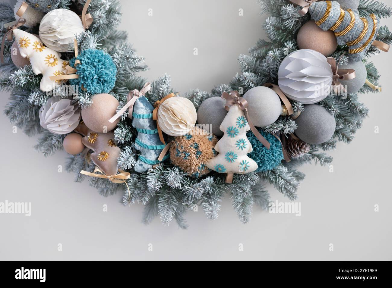 Christmas wreath made of live fir branches and toys on a white ...