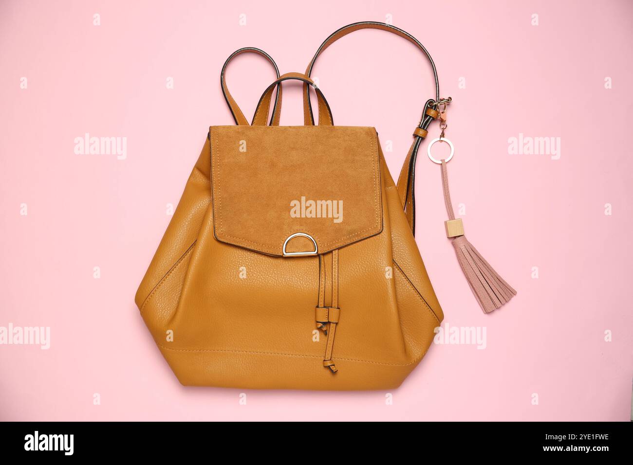 Backpack with leather keychain on pink background, top view Stock Photo