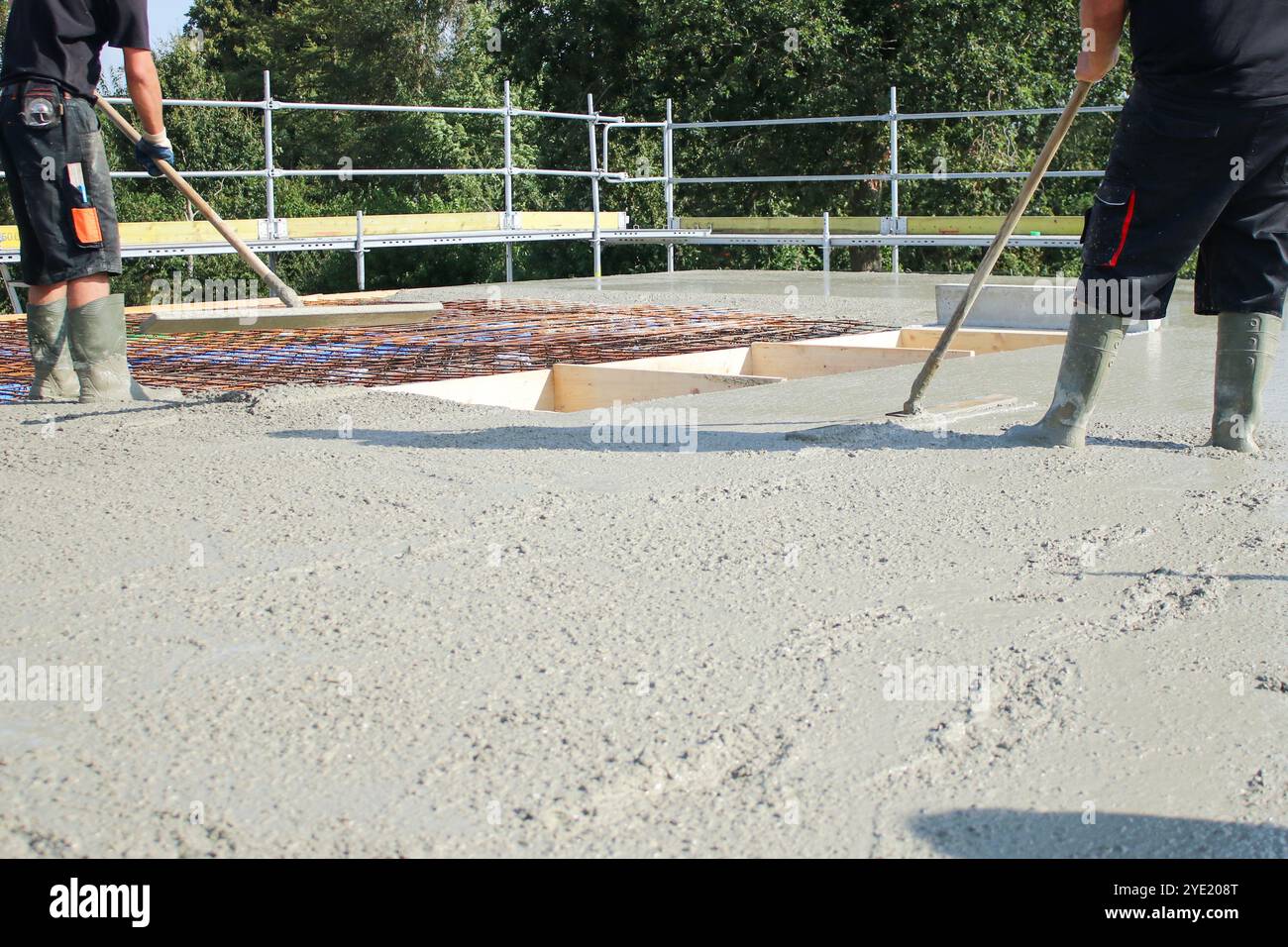 Workers filling the second floor ground with concrete, core and shell ...