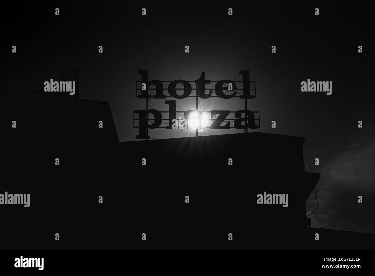 Hotel Plaza Signage Bathed in Morning Sunlight: Autumn’s Warm Embrace. Stock Photo