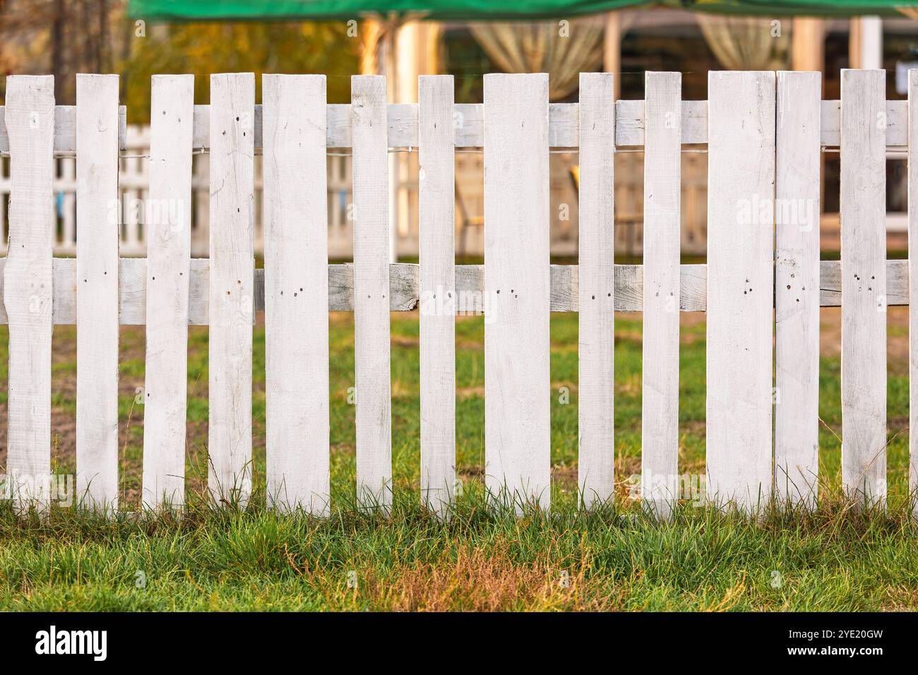 Rustic white wooden fence in the countryside. Close-up of a rustic ...