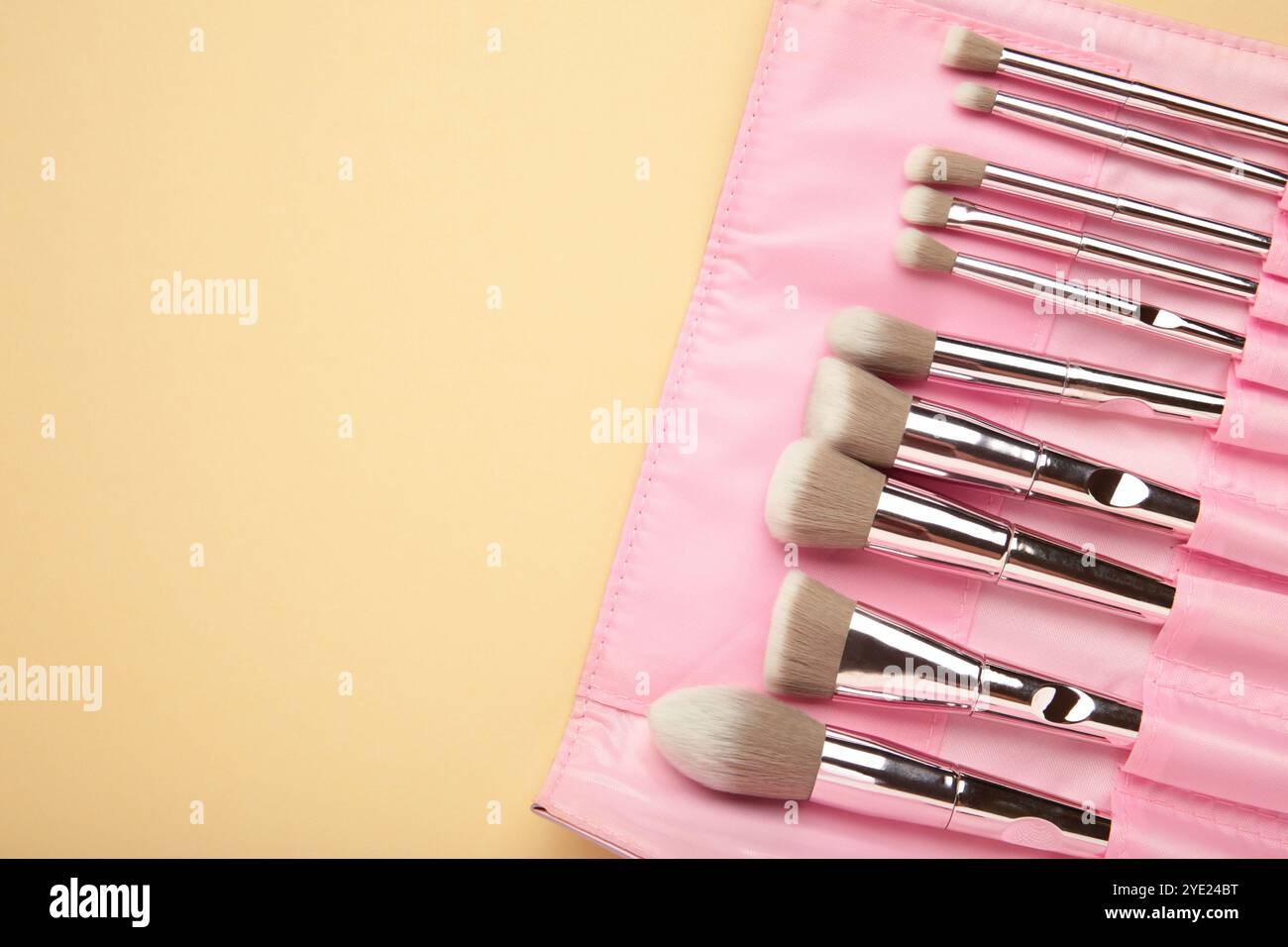 Makeup brushes in beige cosmetic bag. Top view Stock Photo