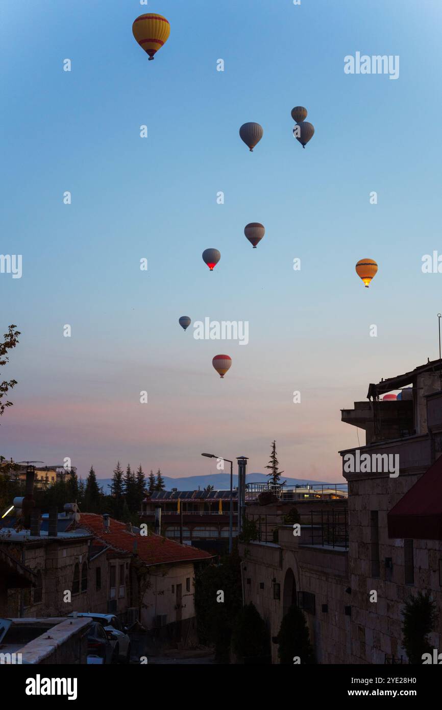 Colorful hot air balloons fly gracefully over a vibrant skyline in ...