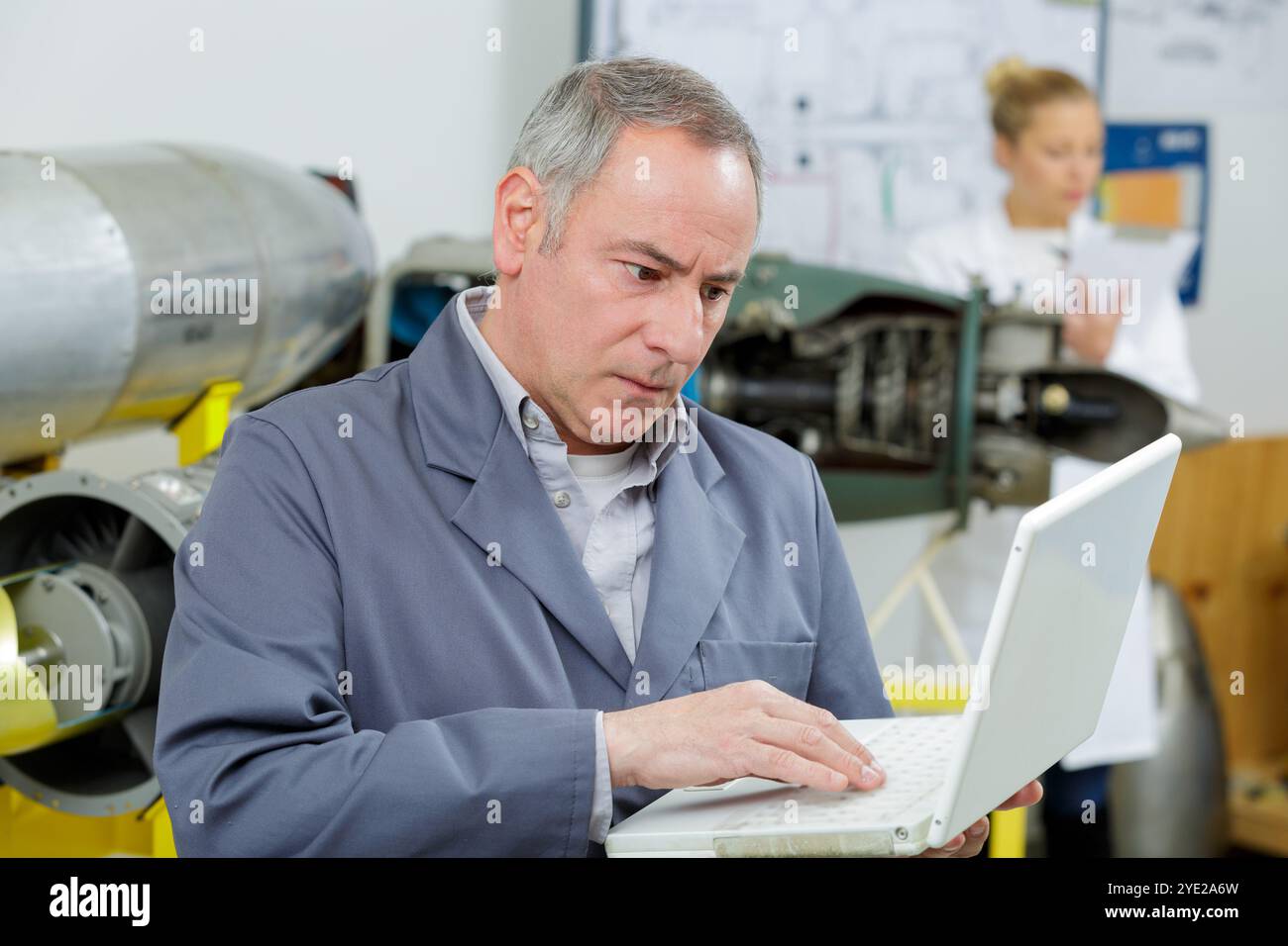 mature engineer with laptop in hands Stock Photo