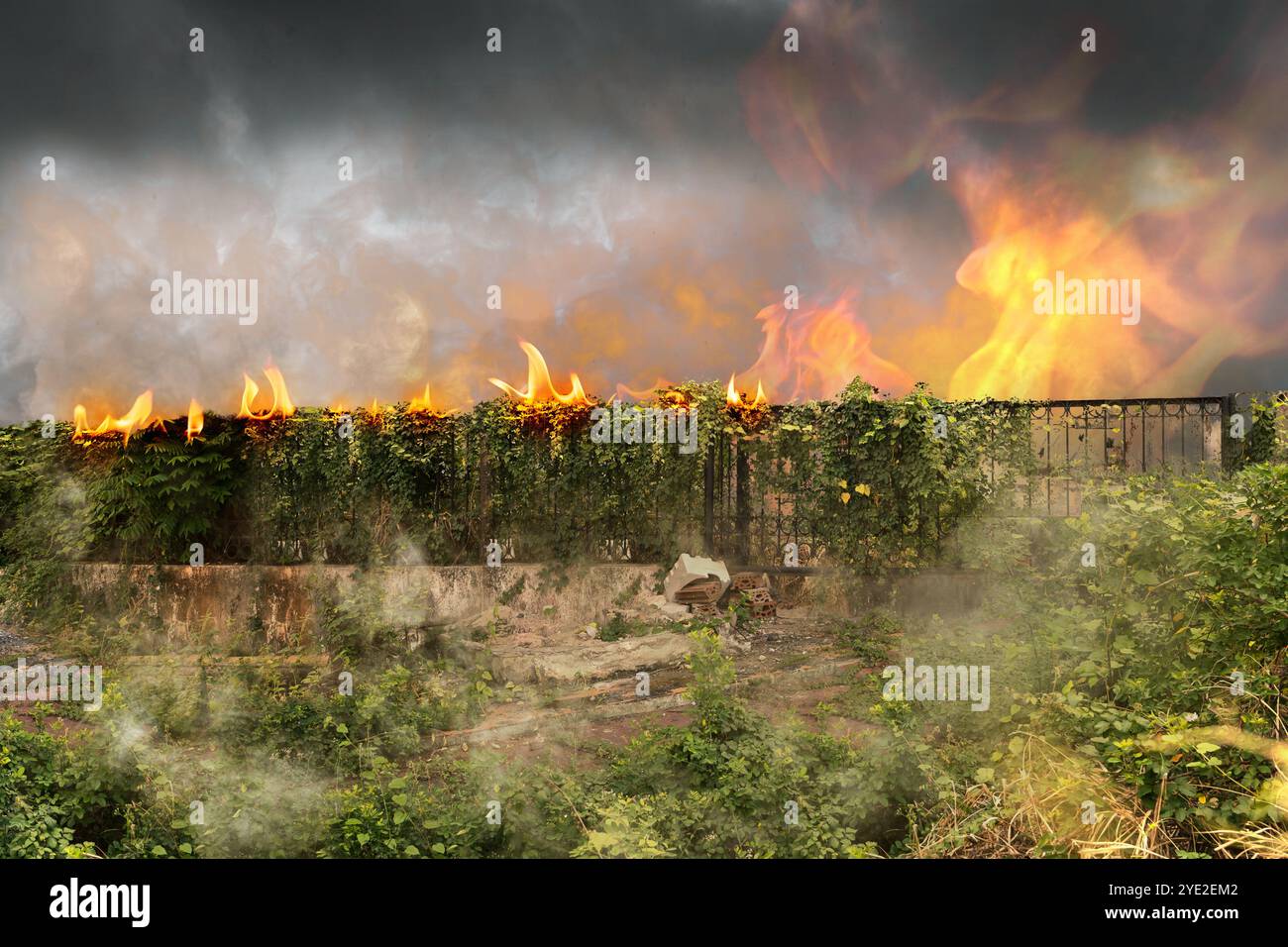 Destruction city with fires explosion with dramatic sky background. Fire is orange and yellow, and it is surrounding and burning buildings. Abandoned Stock Photo