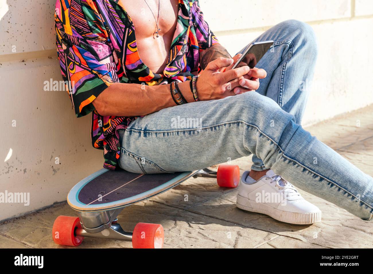 unrecognizable hipster chatting on mobile phone Stock Photo