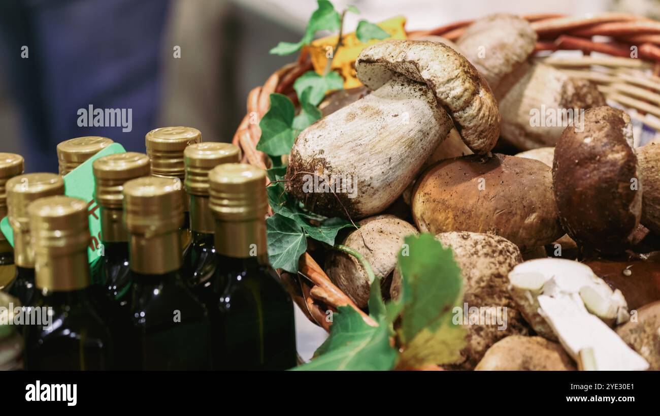 At the Alba Truffle Festival in Italy, visitors admire a selection of fresh truffles alongside local olive oil offerings, celebrating the regions rich Stock Photo