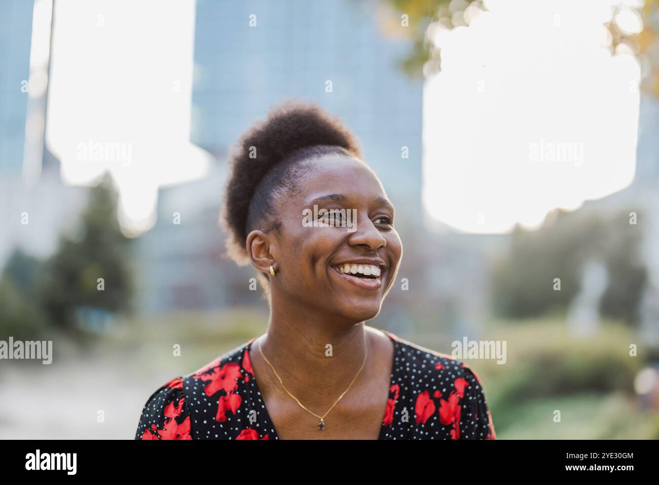 Portrait of a smiling young woman in the city Stock Photo