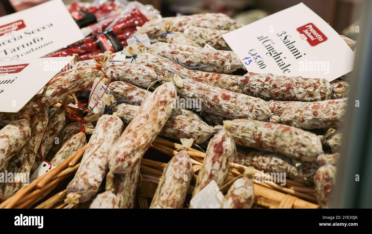 Visitors explore a vibrant stall filled with truffle salami at the Alba ...