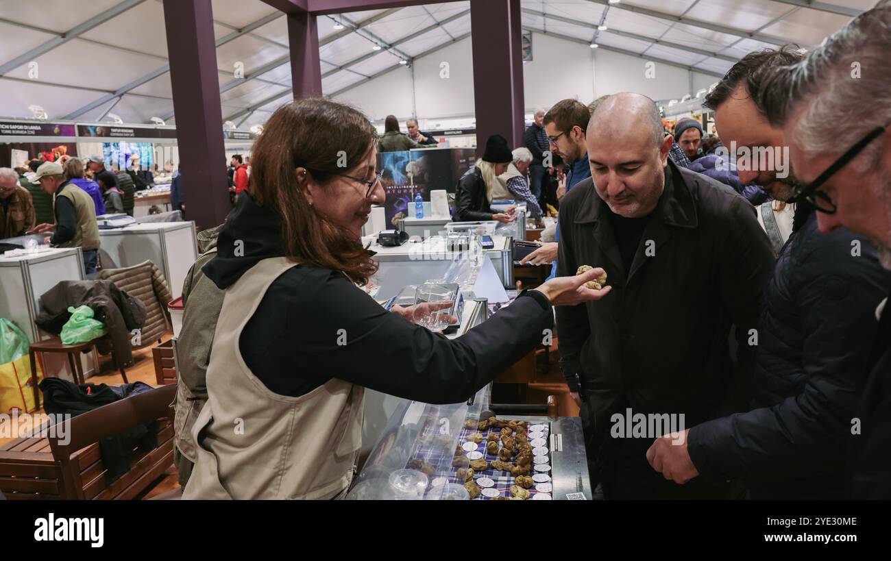 Visitors at the Alba Truffle Festival in Italy sample various truffle ...