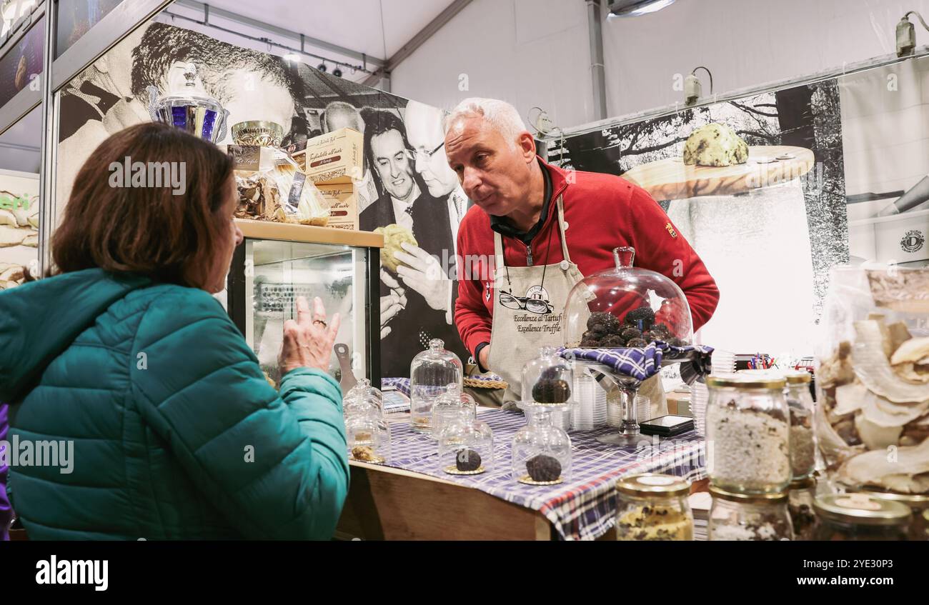 Visitors at the Alba Truffle Festival in Italy interact with vendors ...