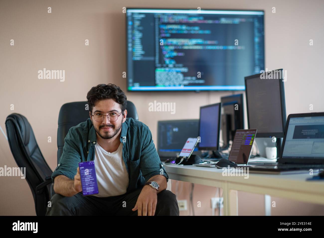 Smartphone Programmer A programmer diligently testing smartphone applications Stock Photo - Alamy