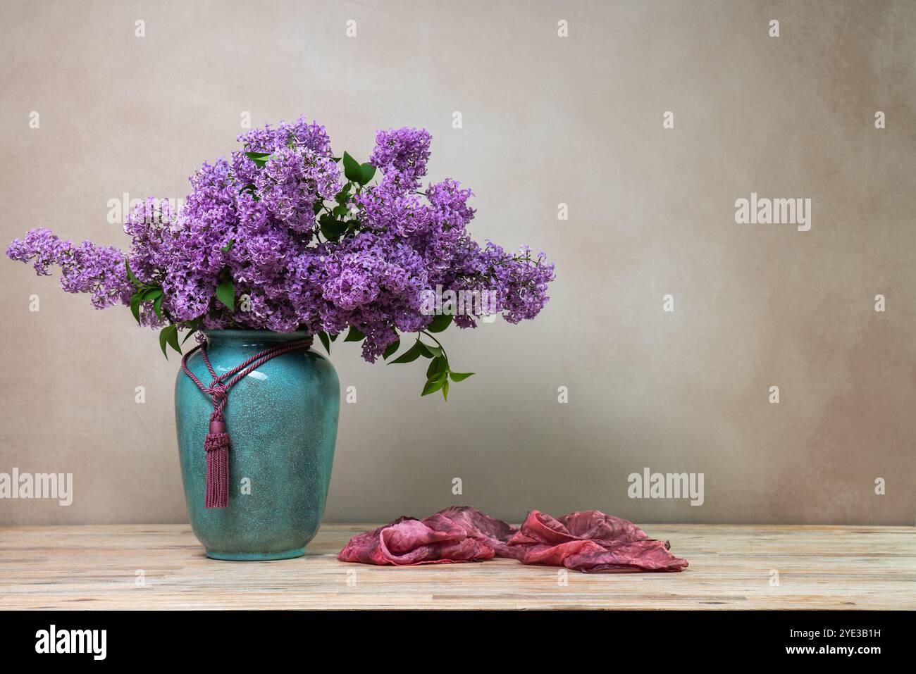 Still life with lilacs. Large bouquet of lilacs in blue vase on light ...
