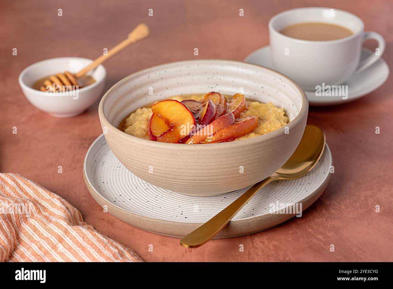 Food photography of millet porridge with caramelized peach, nectarine ...