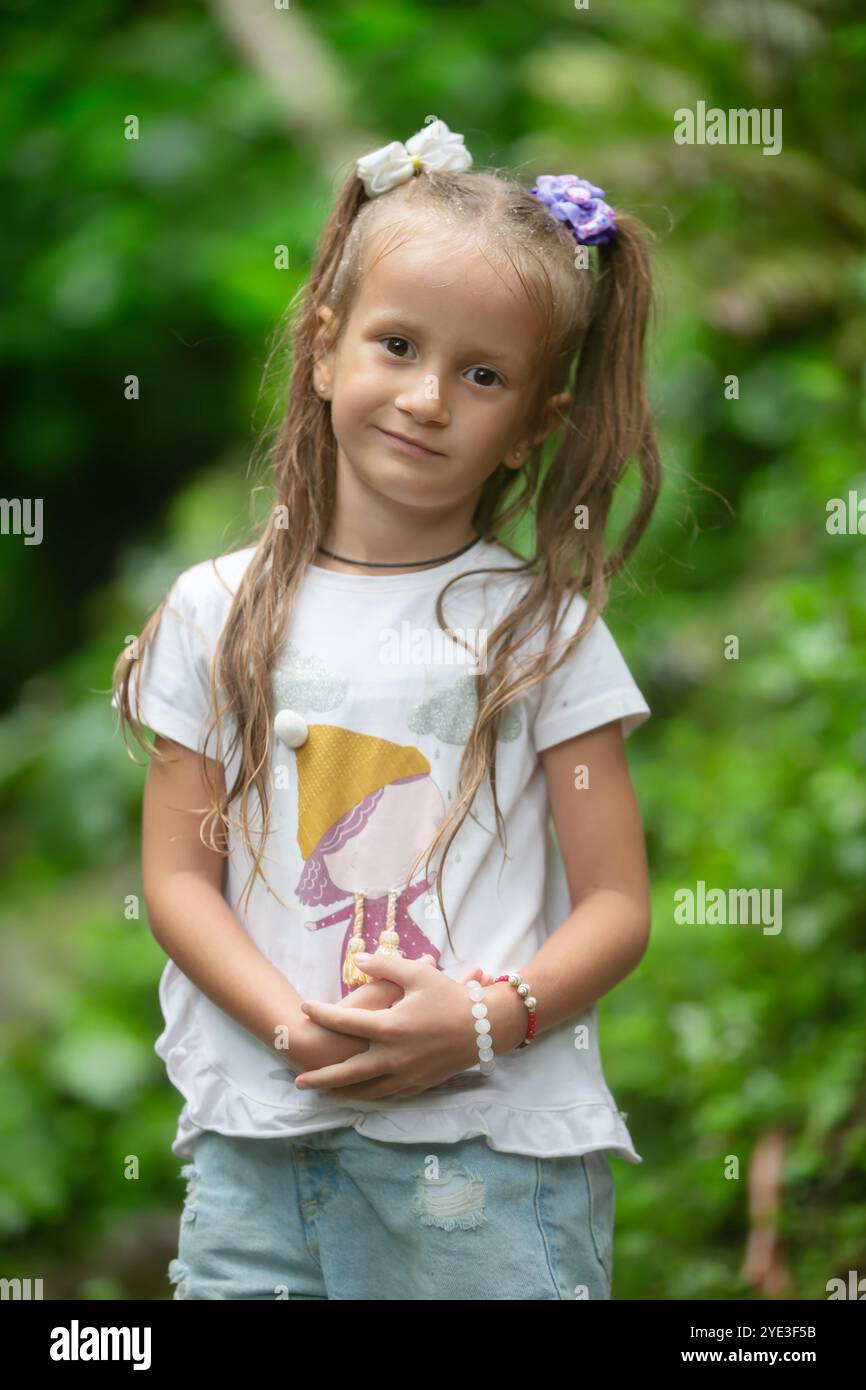 Portrait of a little girl getting wet in the summer rain Stock Photo ...