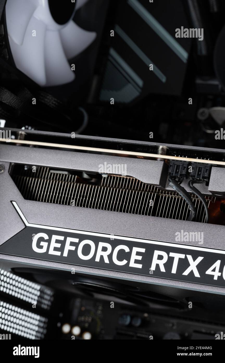 New York, USA - October 24, 2024: Cleaning pc components of graphic card inside gaming computer Stock Photo