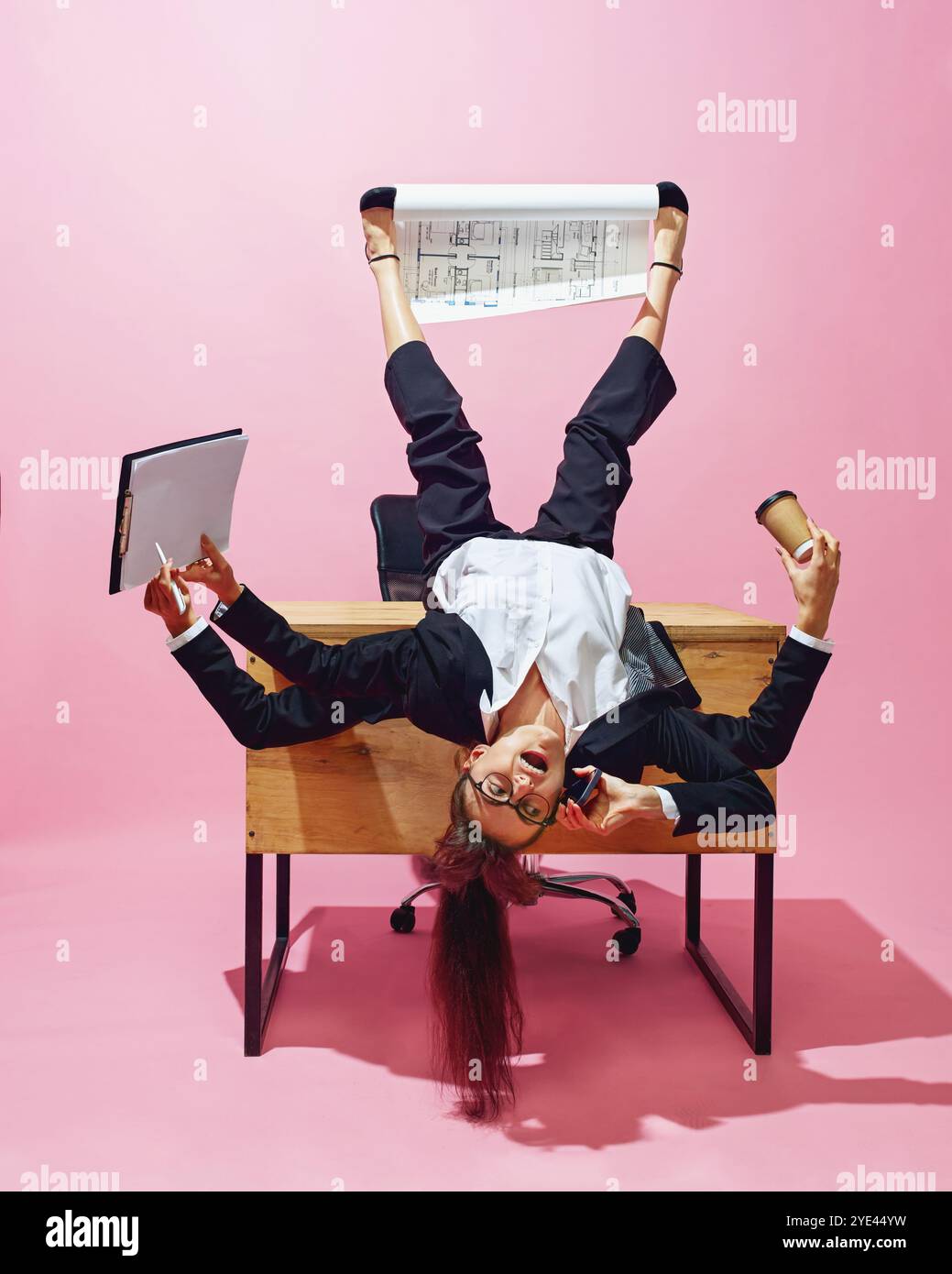 Businesswoman with multiple hands lying on desk, holding cup, documents ...