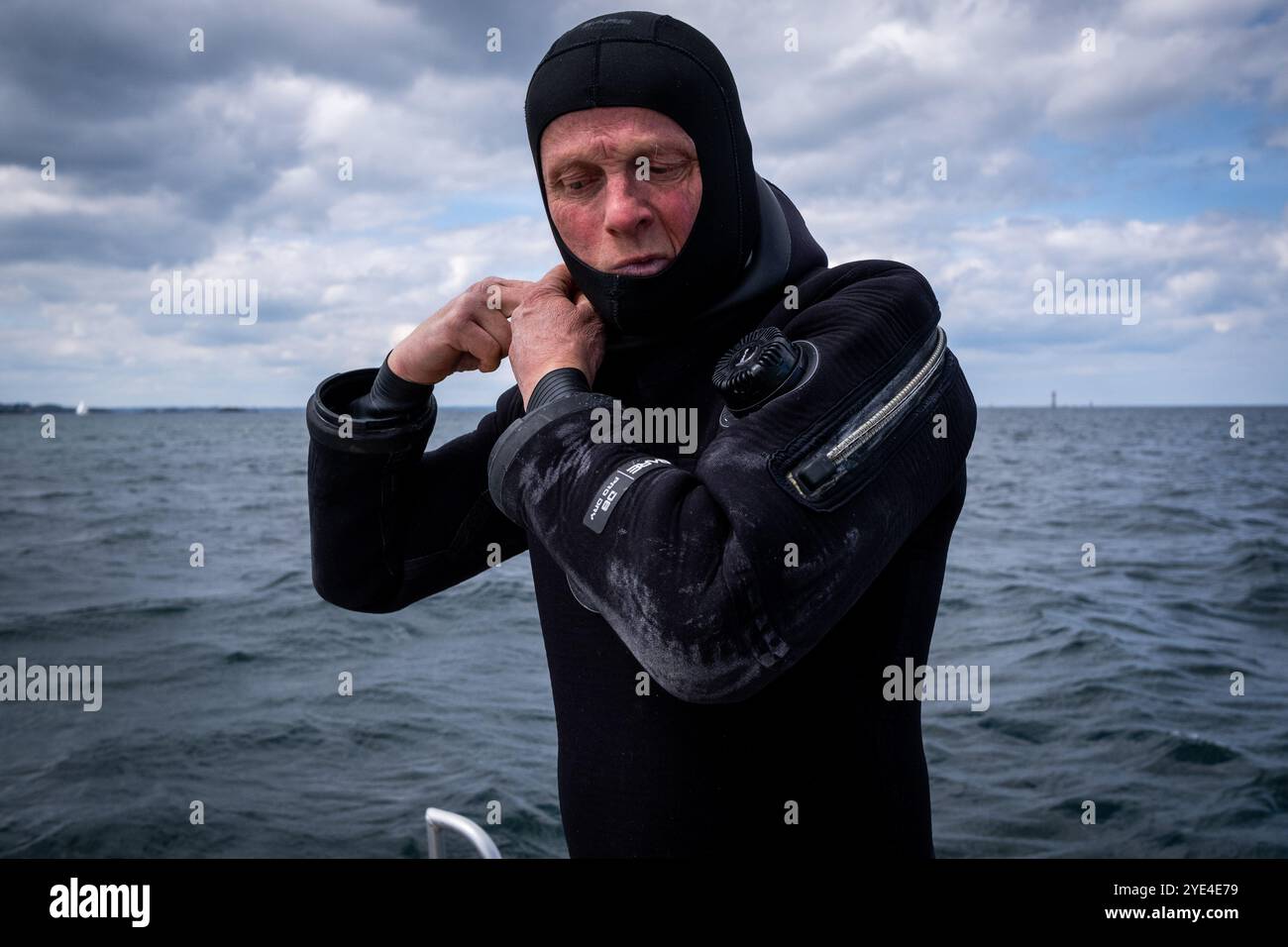 Scallop fisherman scuba diving on the boat in the bay of Saint-Malo in the Ille-et-Vilaine department in the Brittany region of France on 29 April 202 Stock Photo