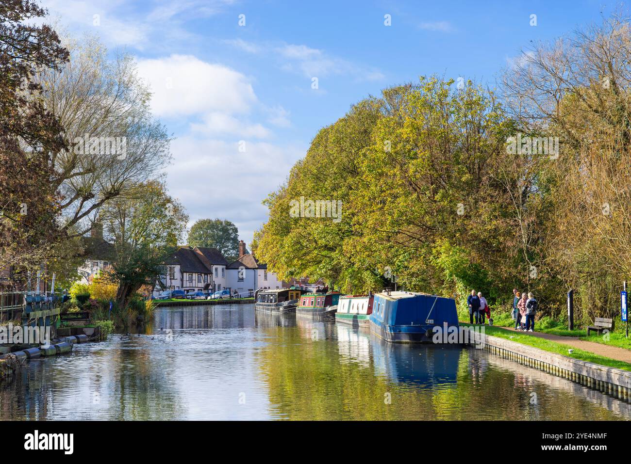 Kennet and Avon Canal boats Newbury Berkshire with people walking on the towpath towards the town centre Newbury Berkshire England UK GB Europe Stock Photo