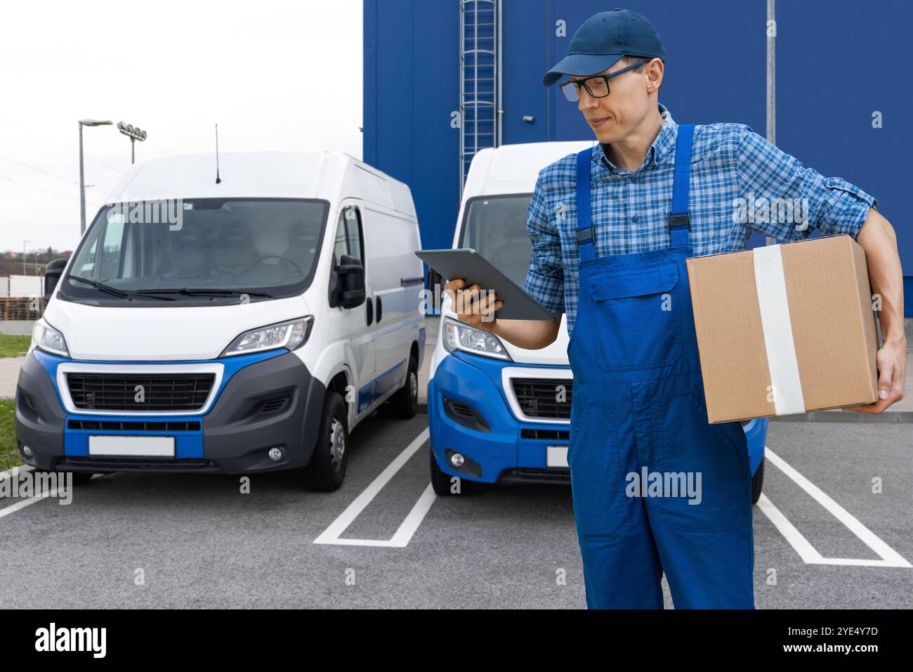 Delivery man in uniform with digital tablet.. Stock Photo