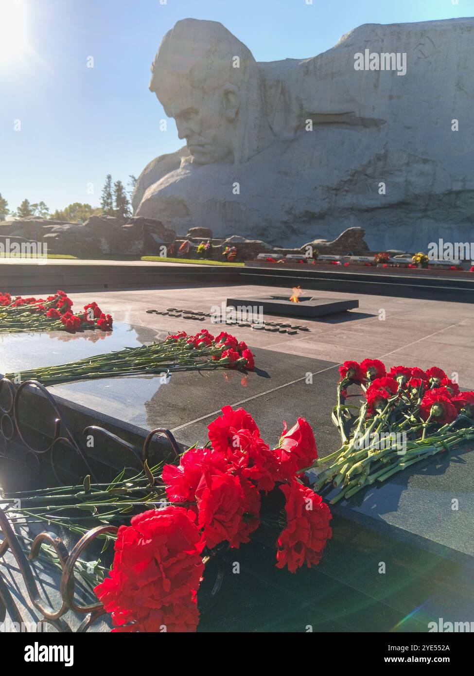 Brest, Belarus - October 19, 2024: Red carnations near the eternal flame of the Brest Fortress Stock Photo