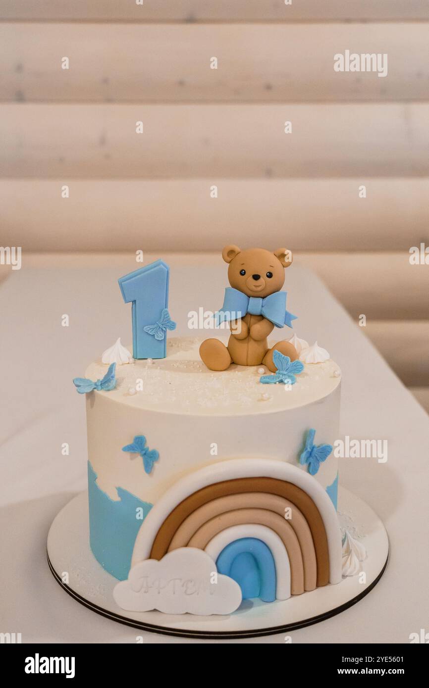 Adorable First Birthday Cake Featuring Teddy Bear and Pastel Decor ...