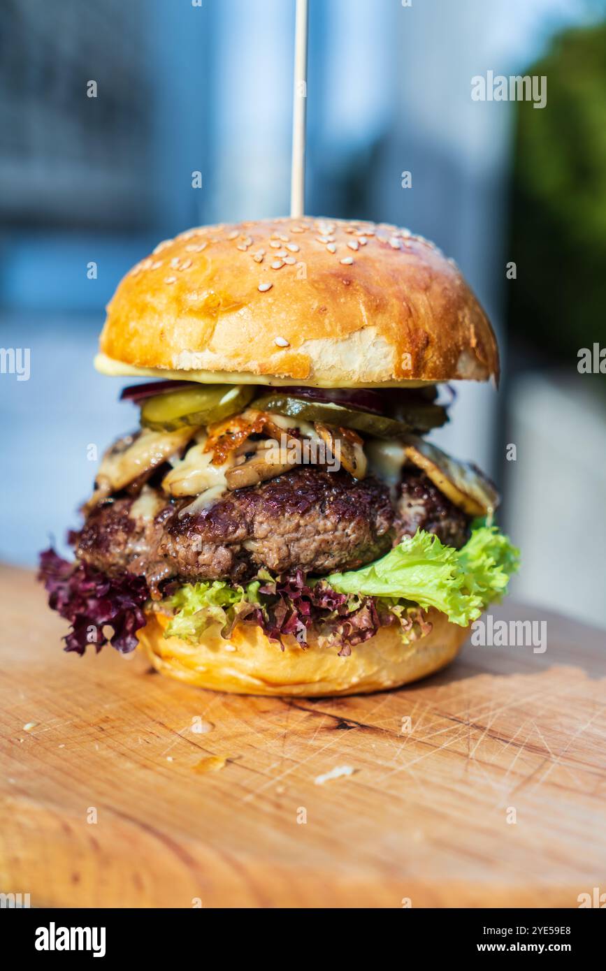 beef burger with vegetables on a wooden board Stock Photo