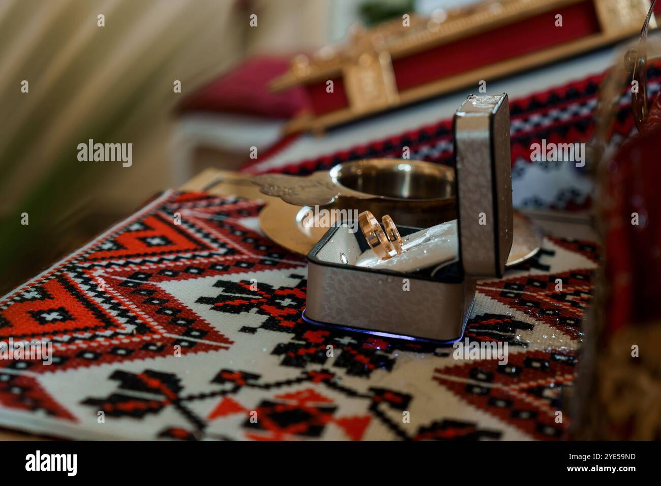 Elegant Wedding Rings Displayed on Traditional Textile Stock Photo - Alamy